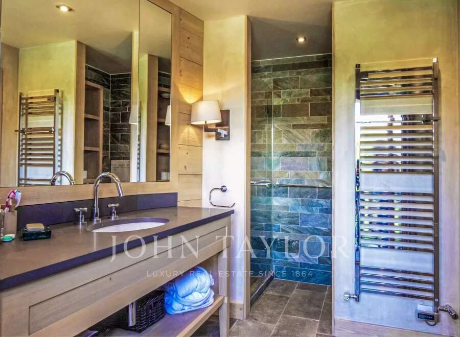 Step into luxury with this stunning bathroom, featuring a sleek vanity and a spa-like shower.