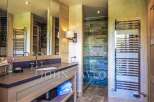 Step into luxury with this stunning bathroom, featuring a sleek vanity and a spa-like shower.