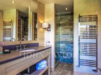 Step into luxury with this stunning bathroom, featuring a sleek vanity and a spa-like shower.
