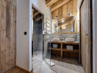 Experience luxury in this stunning bathroom featuring a modern glass shower and elegant double sinks.