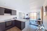 Discover modern living in this stylish property, featuring a sleek kitchen with integrated appliances and ample counter space.