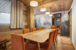 Step into this stunning dining room, where rustic charm meets modern elegance.