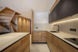 This stunning kitchen boasts a modern design with sleek wooden cabinetry and countertops.