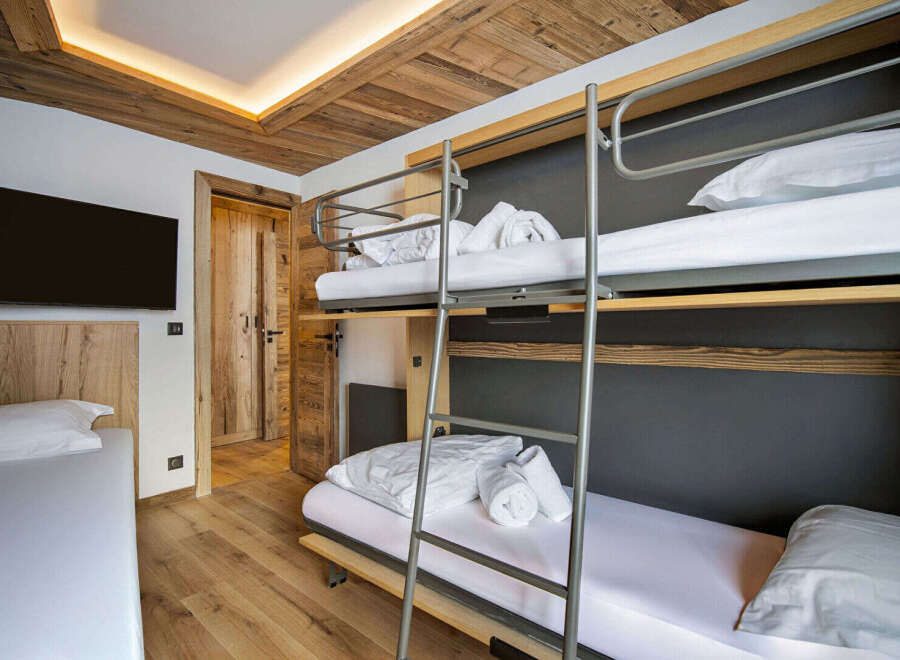 This cozy bedroom features a unique bunk bed setup, perfect for families or groups.
