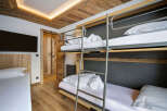 This cozy bedroom features a unique bunk bed setup, perfect for families or groups.