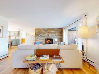This inviting living room features a cozy fireplace, perfect for relaxing evenings.