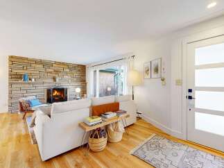 Step into this inviting living space, featuring a cozy fireplace and a stylish, modern design.
