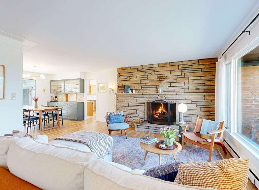 Step into this inviting living space, featuring a cozy fireplace and a stylish, open layout.