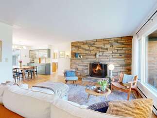 Step into this inviting living space, featuring a cozy fireplace and a stylish, open layout.