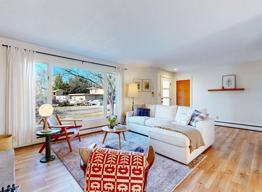 Step into this inviting living space, featuring a cozy fireplace and abundant natural light.