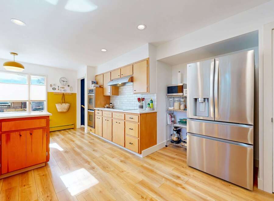 Step into this stunning kitchen, boasting a modern design with sleek stainless steel appliances and ample counter space.
