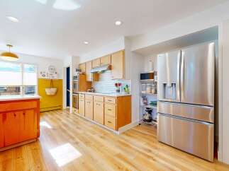 Step into this stunning kitchen, boasting a modern design with sleek stainless steel appliances and ample counter space.