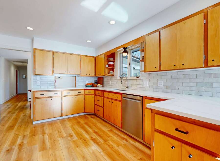 Step into this stunning kitchen, boasting beautiful wooden cabinetry and sleek countertops.