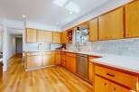 Step into this stunning kitchen, boasting beautiful wooden cabinetry and sleek countertops.