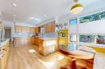 This stunning kitchen boasts a bright and airy atmosphere with its light wood cabinetry and flooring.