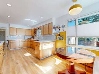 This stunning kitchen boasts a bright and airy atmosphere with its light wood cabinetry and flooring.