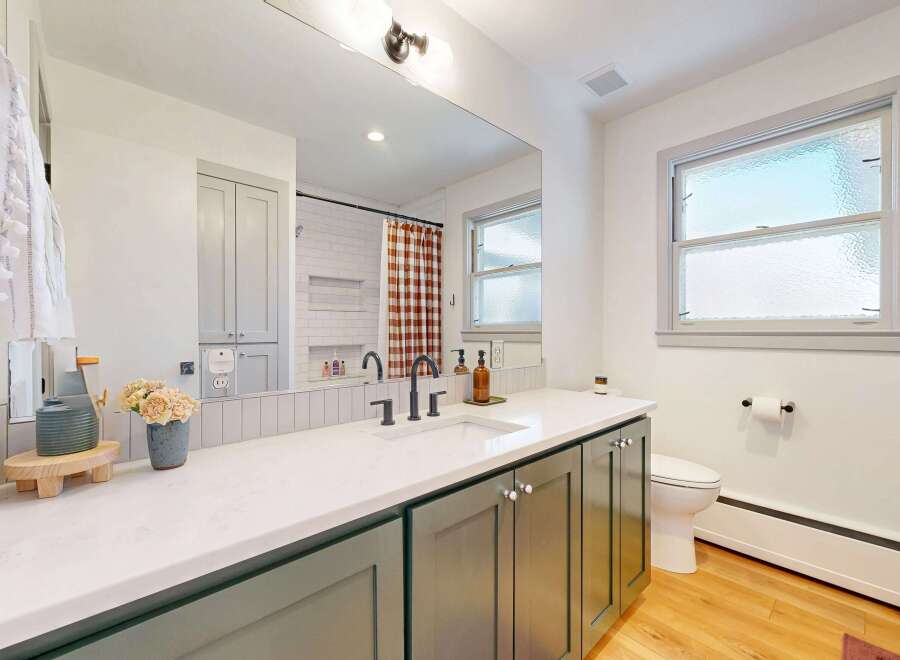 Step into this beautifully designed bathroom, featuring a modern vanity with ample storage and a sleek countertop.