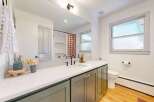 Step into this beautifully designed bathroom, featuring a modern vanity with ample storage and a sleek countertop.
