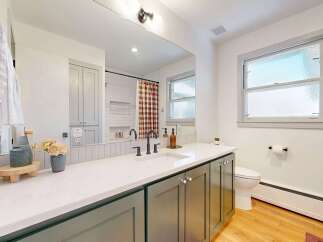 Step into this beautifully designed bathroom, featuring a modern vanity with ample storage and a sleek countertop.