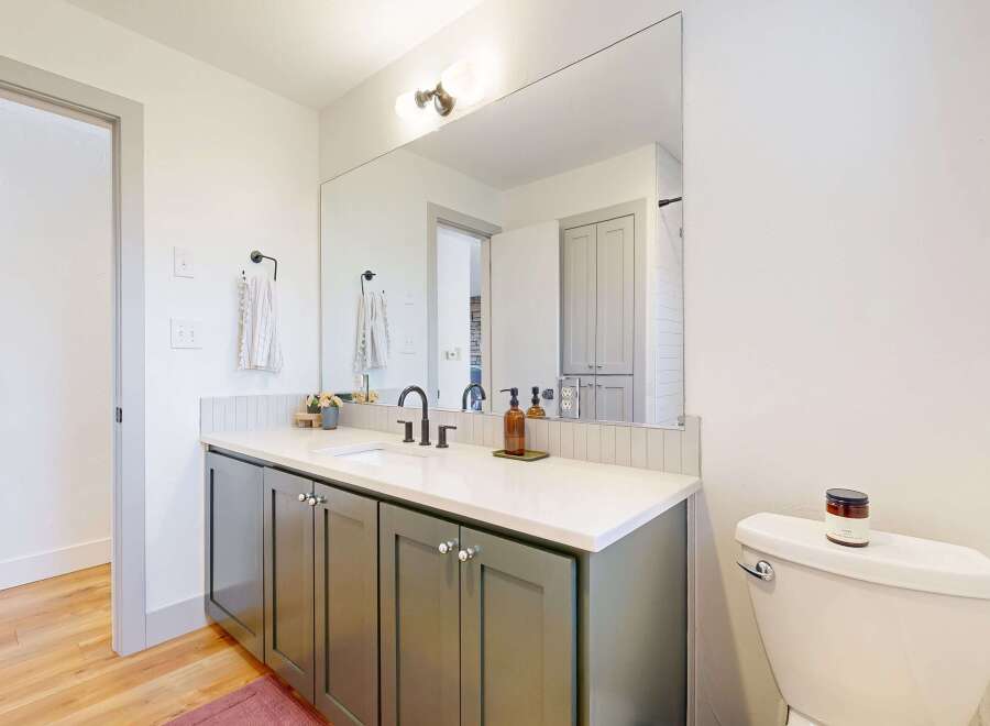 Step into this beautifully designed bathroom, featuring a modern vanity with ample storage and a sleek countertop.