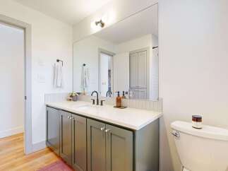 Step into this beautifully designed bathroom, featuring a modern vanity with ample storage and a sleek countertop.