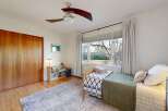 This inviting bedroom features a cozy bed with stylish bedding and a calming color palette.