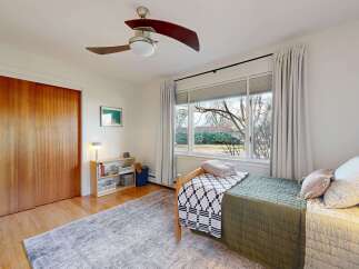 This inviting bedroom features a cozy bed with stylish bedding and a calming color palette.