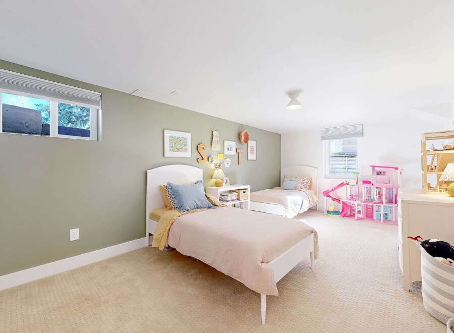 This charming bedroom features two twin beds, perfect for a shared space or guest room.