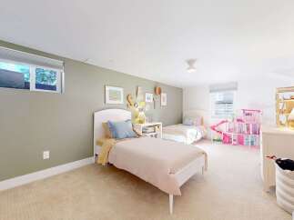 This charming bedroom features two twin beds, perfect for a shared space or guest room.