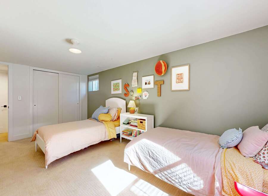 This charming bedroom features two twin beds, perfect for a shared space or guest room.