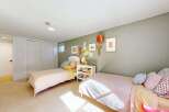 This charming bedroom features two twin beds, perfect for a shared space or guest room.