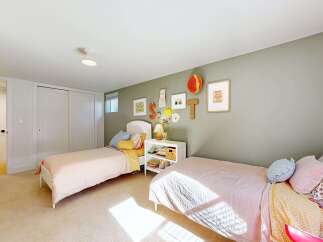 This charming bedroom features two twin beds, perfect for a shared space or guest room.