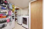 This laundry room offers a functional and organized space.