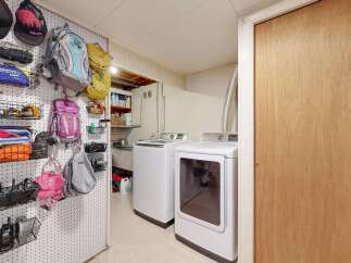 This laundry room offers a functional and organized space.