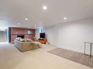 Step into this inviting living space, featuring a cozy fireplace and a comfortable sofa, perfect for relaxing evenings.