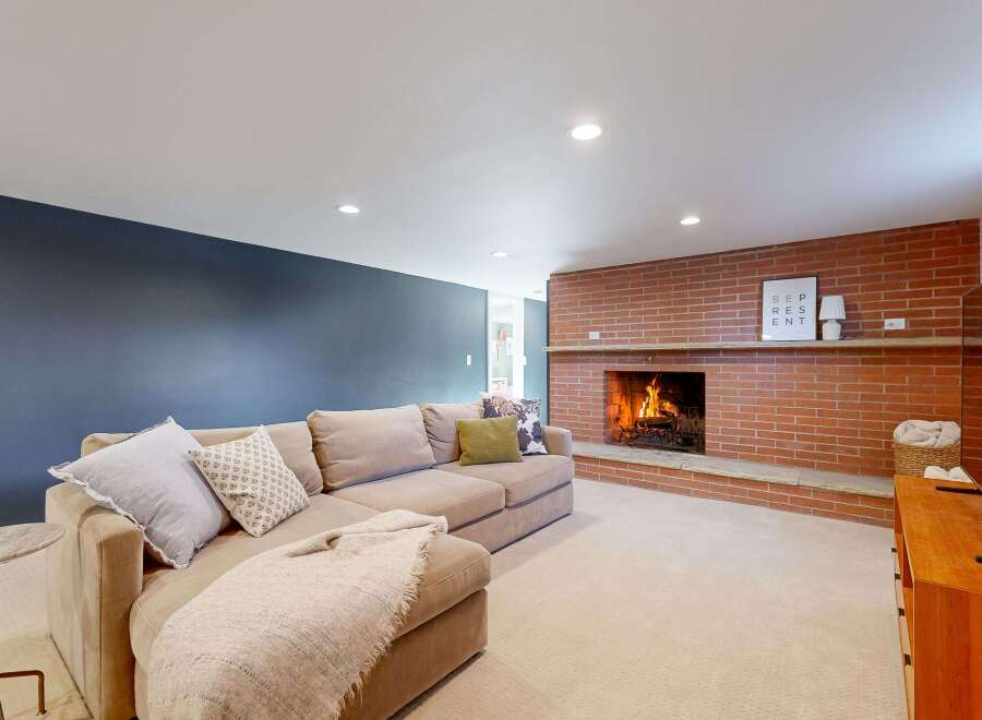 This cozy living room features a stunning brick fireplace, perfect for creating a warm and inviting atmosphere.