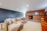 This cozy living room features a stunning brick fireplace, perfect for creating a warm and inviting atmosphere.