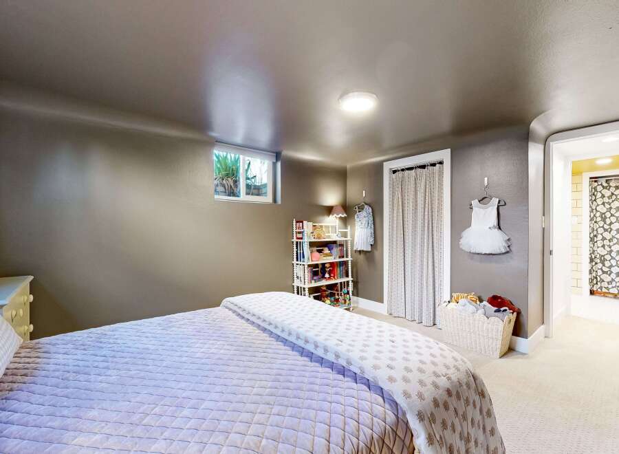 This charming bedroom offers a cozy and inviting atmosphere, perfect for relaxation.