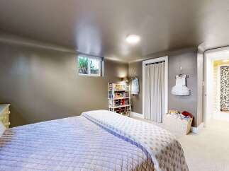 This charming bedroom offers a cozy and inviting atmosphere, perfect for relaxation.