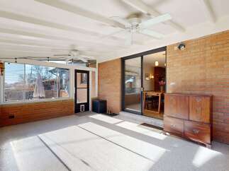 Step into this inviting sunroom, perfect for relaxation and entertaining.