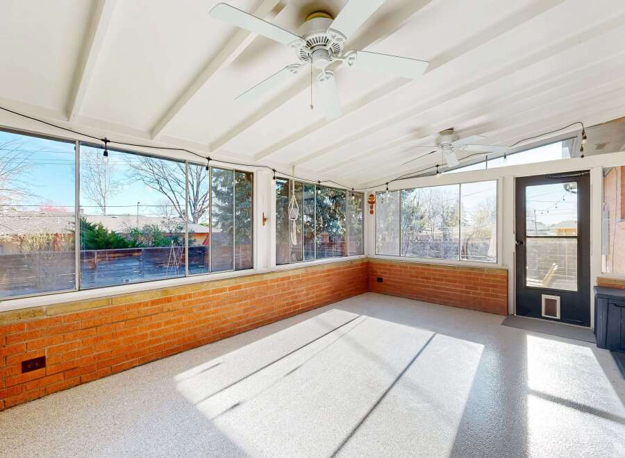 Enjoy the natural light in this sun-drenched sunroom, perfect for relaxation and entertaining.