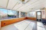 Enjoy the natural light in this sun-drenched sunroom, perfect for relaxation and entertaining.