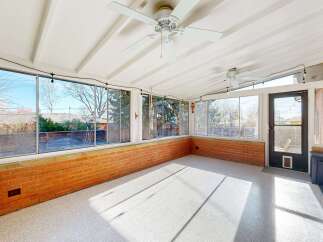 Enjoy the natural light in this sun-drenched sunroom, perfect for relaxation and entertaining.