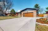 This stunning property boasts a modern design with a beautiful wooden garage door and a spacious driveway.