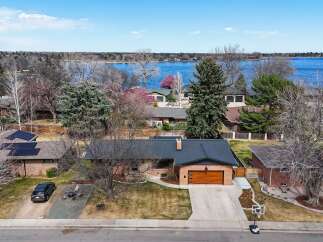 This stunning property offers a serene lakeside living experience with breathtaking views.