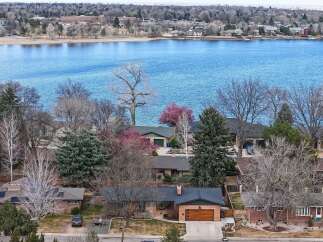 Discover the charm of lakeside living in this stunning property! This home boasts a prime location with breathtaking views of the water, perfect for enjoying serene mornings and vibrant sunsets.