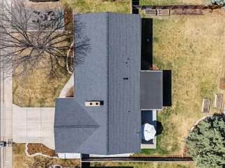 This stunning property boasts a beautifully maintained exterior with a modern roof and a spacious backyard.