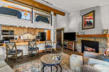 This cozy living space features a stunning stone fireplace, perfect for those chilly evenings.