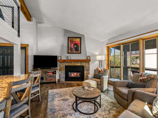 This stunning property boasts a cozy living room with a fireplace, perfect for relaxing evenings.