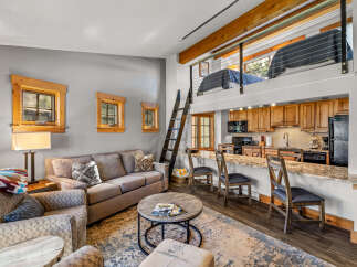 Discover the charm of this cozy cabin featuring a loft bedroom and a well-equipped kitchen.
